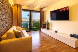 a living room with a couch and a flat screen tv at La Dimora dell'Ufficiale DELUXE in Foligno