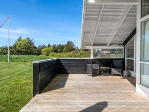 an outdoor deck with awning on a house at Holiday Home Eddi - 550m from the sea by Interhome in Løkken