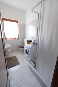 a white bathroom with a toilet and a window at Estar Sogni by PortofinoVacanze in Rapallo +43 photos