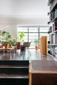 a living room with a large window and bookshelves at Canning Town Serviced Apartment in London