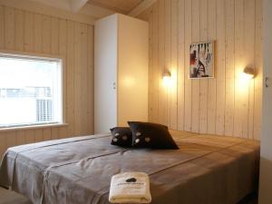 a bedroom with a bed with a laptop on it at Holiday Home Asol - 650m from the sea by Interhome in Løkken