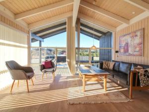 a living room with a couch and chairs and a table at Holiday Home Asol - 650m from the sea by Interhome in Løkken