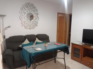 a living room with a couch and a table at Apartamento La Reina Home in Córdoba