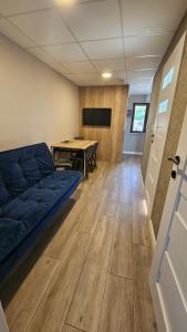 a living room with a couch and a ping pong table at Killarney Cosy Hideaway in Killarney