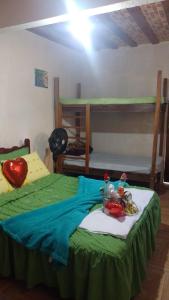 a bedroom with two bunk beds with a green bedspread at Villa Monteiro in Macaé +14 photos