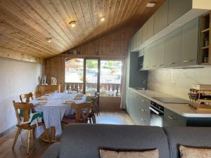 eine Küche mit einem Tisch und Stühlen in einer Küche in der Unterkunft Duplex lumineux 3 pièces, 7 pers, 3 balcons, proche pistes et commerces, parking, ski bus - FR-1-572-72 in Arâches-la-Frasse + 9 Fotos
