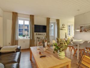 a living room with a table and a dining room at Apartment Ingert - 250m from the sea by Interhome in Løkken