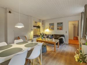 a living room with a table and chairs and a couch at Apartment Ingert - 250m from the sea by Interhome in Løkken