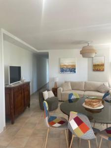 a living room with a couch and a table at Gîte La Tournelle in Crest