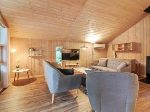 a living room with a couch and chairs at Holiday Home Elsemaria - 1-3km from the sea by Interhome in Løkken