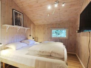 a bedroom with a bed in a wooden wall at Holiday Home Elsemaria - 1-3km from the sea by Interhome in Løkken +21 photos