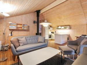 a living room with a couch and a table at Holiday Home Elsemaria - 1-3km from the sea by Interhome in Løkken