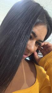 a woman with long black hair talking on a cell phone at hotel larenaaa in Sete Lagoas +2 photos