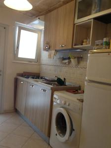 a kitchen with a washing machine and a washer at Sea Home 2 in Monopoli