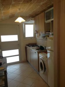 a kitchen with a stove and a washer and dryer at Sea Home 2 in Monopoli