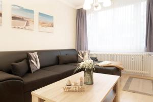 a living room with a couch and a coffee table at Tannenburg Wohnung 205 in Grömitz