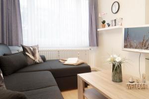 a living room with a couch and a table at Tannenburg Wohnung 205 in Grömitz +35 photos