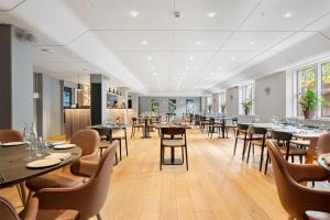 a restaurant with tables and chairs in a room at Best Western Hotel Hillerød in Hillerød