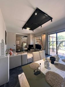 a living room with a couch and a table at Charming Modern Villa with swimming pool in El Aggada