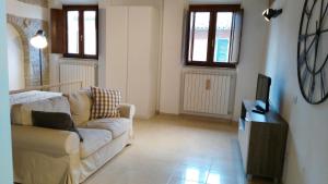 a living room with a couch and a tv at Lally House in Pesaro