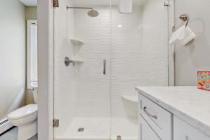 a white bathroom with a shower and a toilet at Frozen Jamaica in Jamaica +22 photos