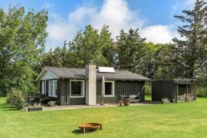 a small house in a field with a yard at LN1943-Lonstrup-Fuglegraesvej-6 in Lønstrup