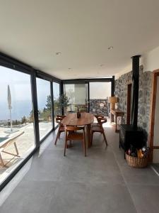 a dining room with a table and a large window at Casa Arriettas in Tijarafe