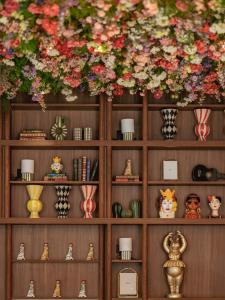 a wooden shelf with vases and flowers on it at Chachacha Hôtel in Nantes