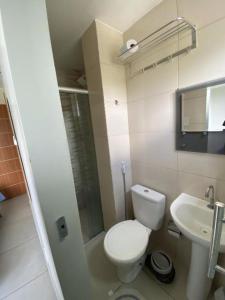 a small bathroom with a toilet and a sink at Hangar House in Belém
