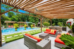 an outdoor patio with a pergola and a swimming pool at Buendía Lux Lotus Suite Hidden Gem Near Beach with Pool in Potrero