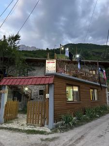 a building with a balcony on top of it at GUEST HOUSE “ Center Theth “ in Theth +29 photos