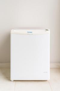 a white refrigerator in a room at Maestro in Fortaleza