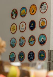 a wall with a bunch of stickers on a wall at Pousada Porto Verano in Porto De Galinhas +49 photos
