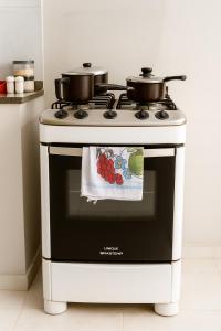 a stove with two pots on top of it at Maestro in Fortaleza