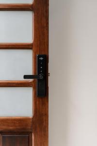 a wooden door with a black door handle at Maestro in Fortaleza