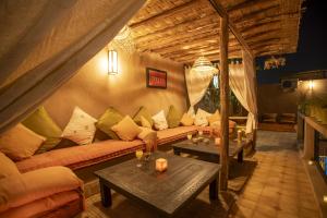 un salon avec un canapé et deux tables dans l'établissement Riad Tala, à Marrakech 16 autres photos