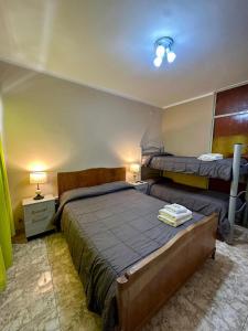 a bedroom with two beds and two lamps in it at Hotel Interlagos in San Juan