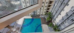 a view from the balcony of a building with a swimming pool at Casa Vides at Victoria Sports Tower beside GMA Kamuning MRT Station in Manila