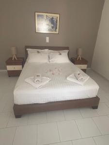 a bedroom with a bed with two towels on it at Dolphin Apt & Studios -Near the Beach in Roda