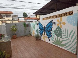 a butterfly painted on the side of a wall at Refúgio de Piratininga 204 in Niterói