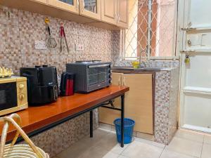 a kitchen with a counter top with a microwave at Shalom Homes in Kampala