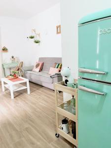 a living room with a couch and a refrigerator at Abades South Beach Domi,air,wifi ,parking in Abades