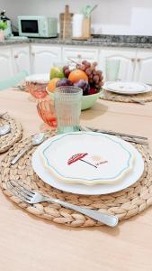 a table with a plate and a bowl of fruit at Abades South Beach Domi,air,wifi ,parking in Abades +44 photos