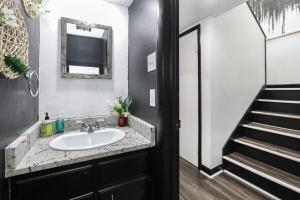 a bathroom with a sink and a mirror and a staircase at Cheerful Hot Springs Village Condo in Hot Springs +11 photos