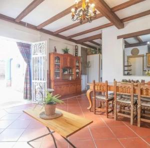 a kitchen and dining room with a table and chairs at Spacious Villa in Guillena with Garden and Private Pool in Guillena