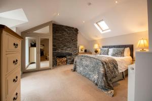 a bedroom with a bed and a stone wall at Shore Hotel in Port Saint Mary