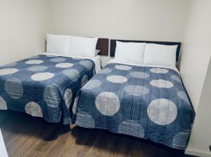 two beds sitting next to each other in a room at Stay Lodge of Decatur in Decatur