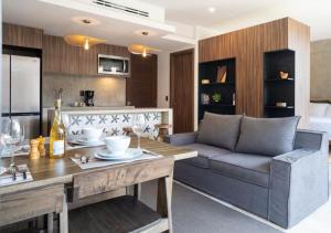 a living room with a couch and a table at Ideal Location with Cenote Pools Gym Restaurant in Tulum