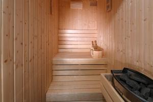 a wooden sauna with a wooden step in it at SPA Apartment Adriatico in Rijeka