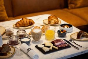 a table with a bunch of breakfast foods on it at Markus in Angers